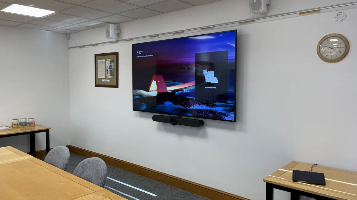A meeting room with a wall display and video bar installed by AV Xpert in Bedford