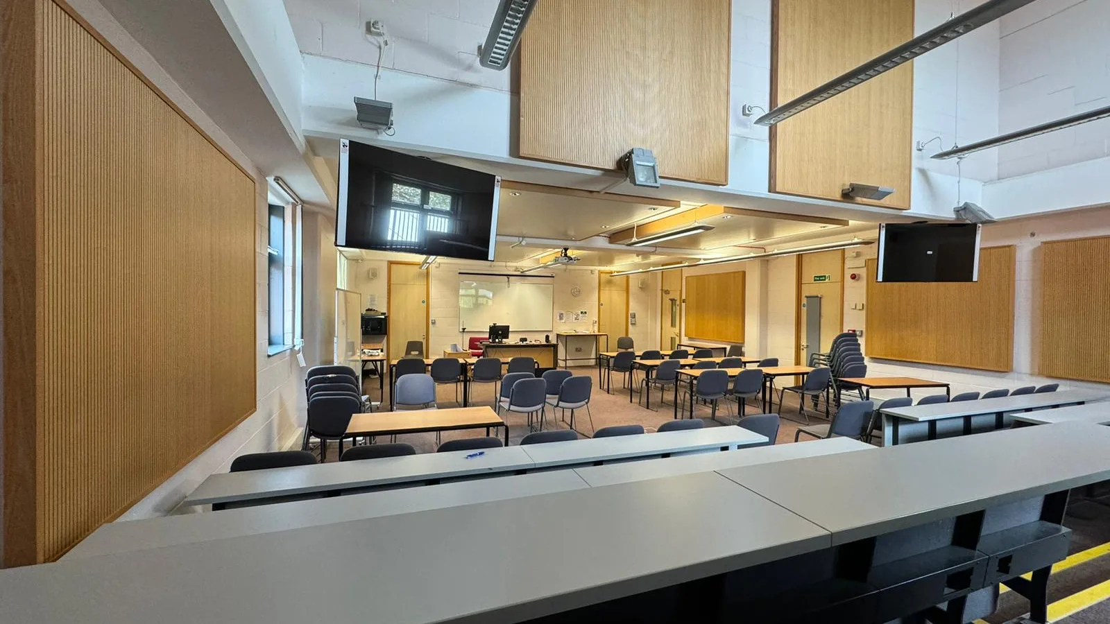 A teaching space with ceiling-mounted displays installed by AV Xpert at a Cambridge college