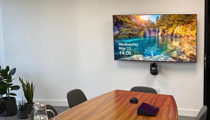 A meeting room with a wall display and camera installed by AV Xpert in a London office