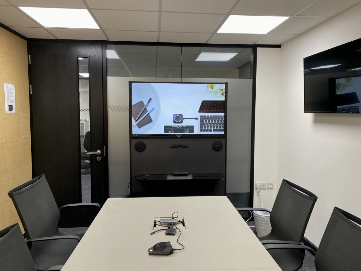 A portable video conferencing unit at the end of the IQGeo boardroom table