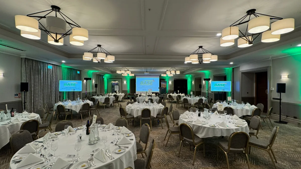 A conference dinner with screens, uplighting and sound from AV Xpert