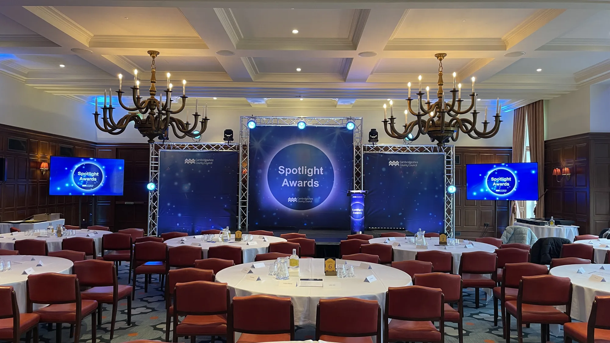 Branded screens either side of a conference stage