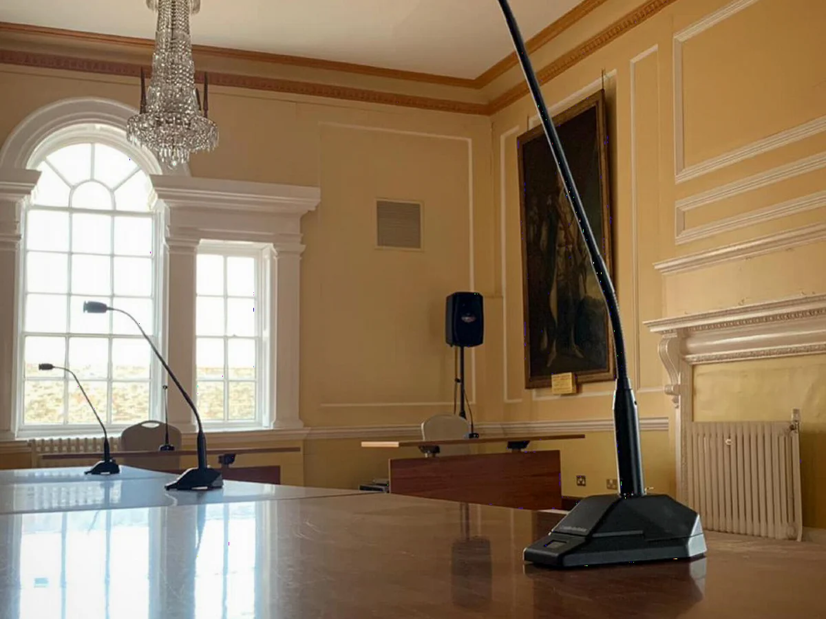 Gooseneck microphones set up in a historic hall