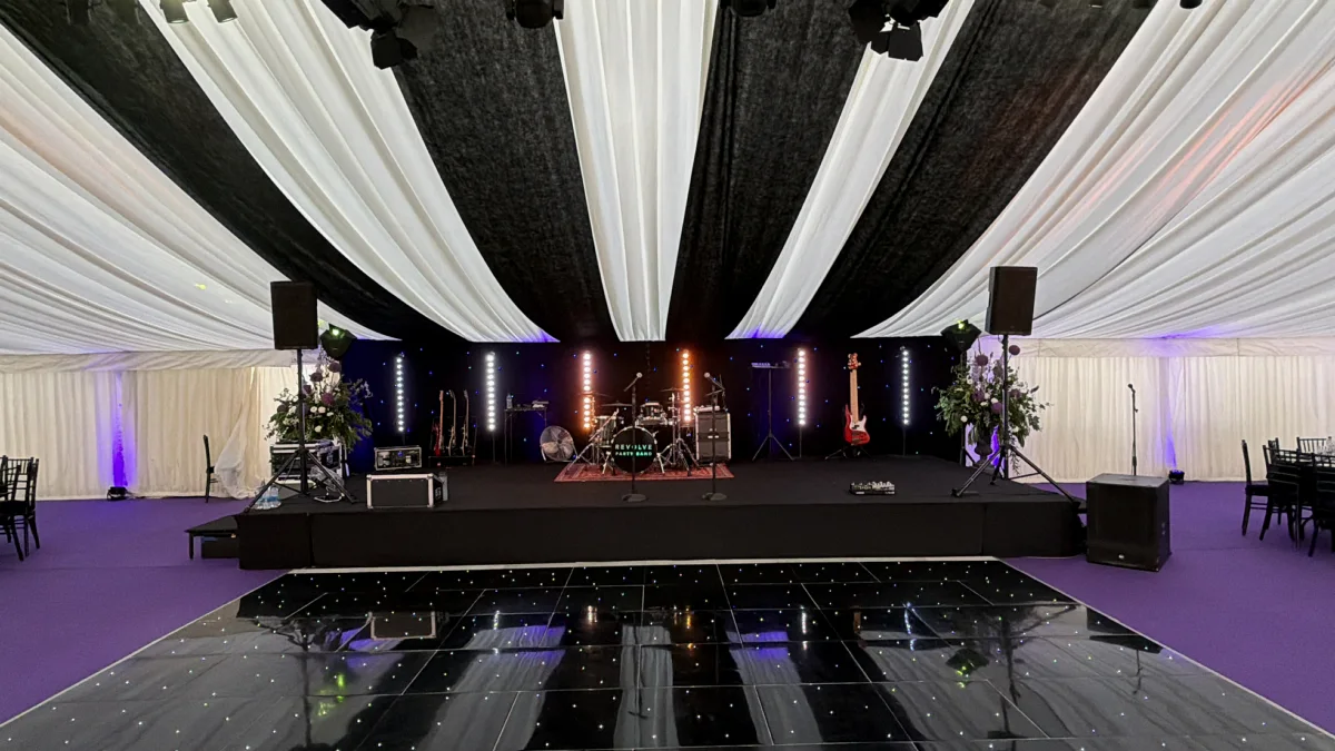 A large marquee with a stage, band set-up, lighting and a dance floor from AV Xpert