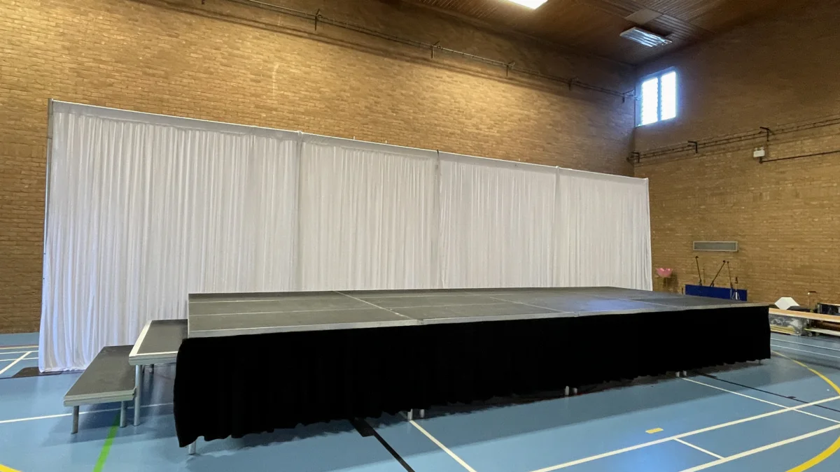 Staging with drapes set up by AV Xpert in a sports hall