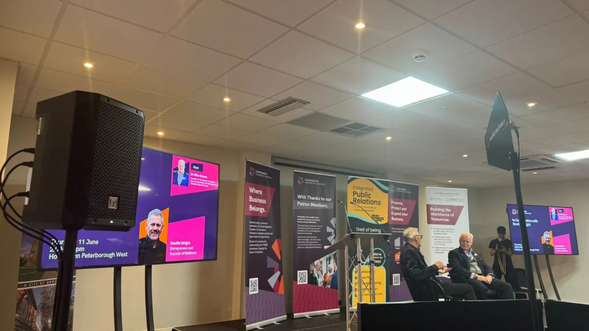 A speaker and screen at a business conference