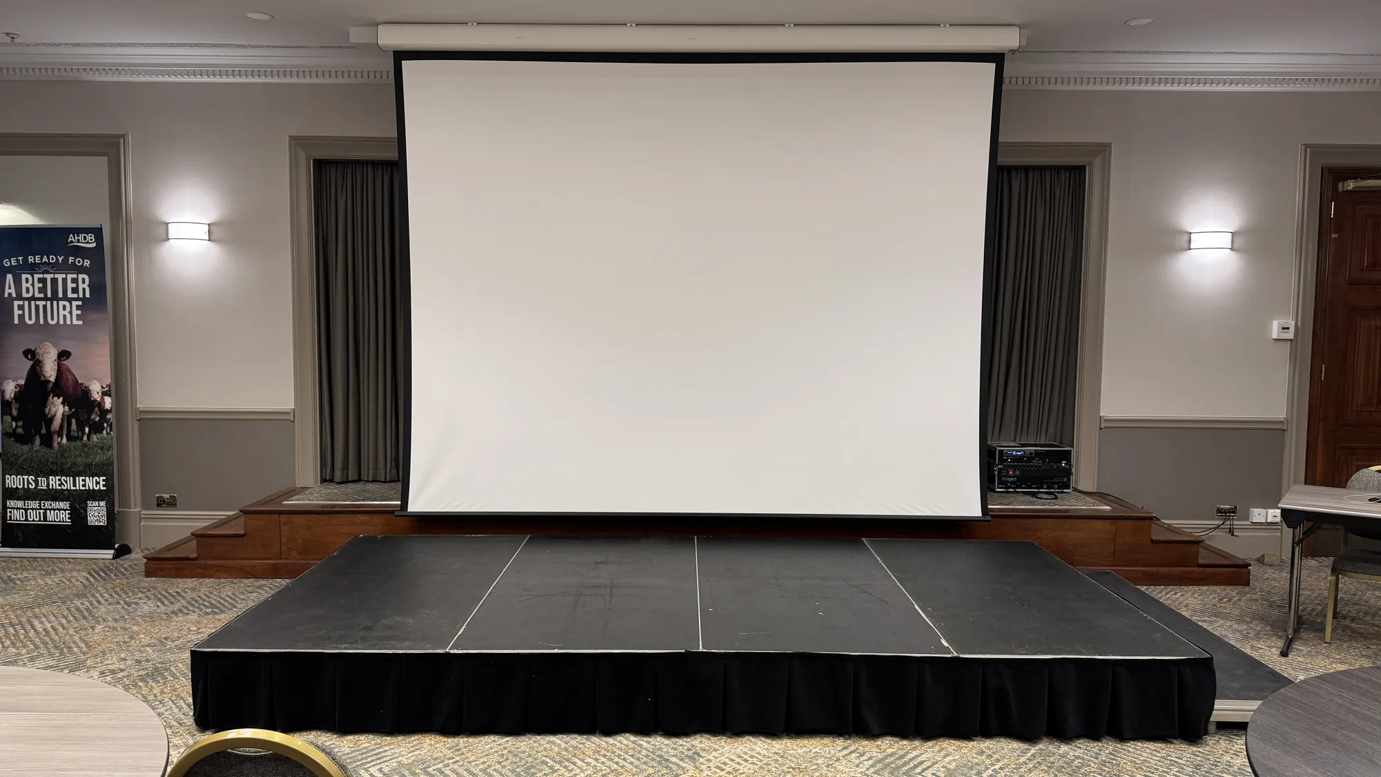 A projector screen on a stage, hired from AV Xpert