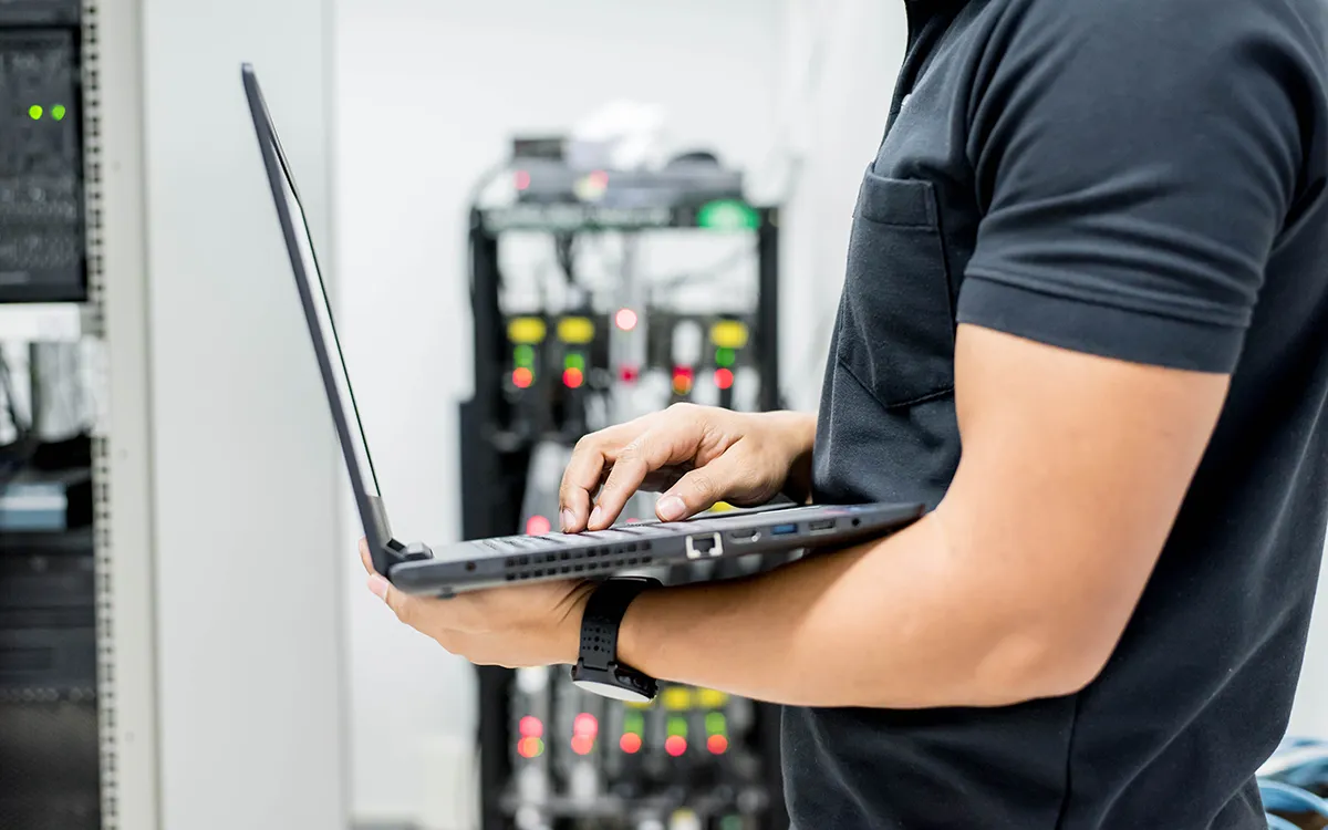 Audio-visual engineer troubleshooting in server room