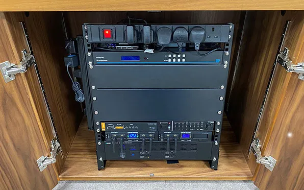 Installed audio-visual system equipment rack in credenza